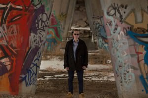 Patrick standing near graffiti